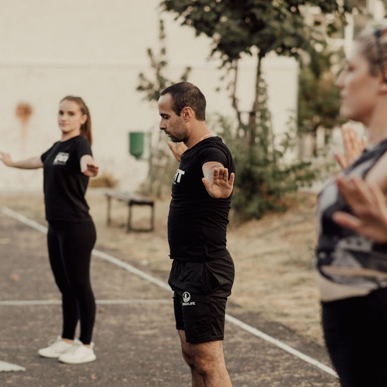 Adults engaging in outdoor fitness exercise in a park setting, staying active and healthy.